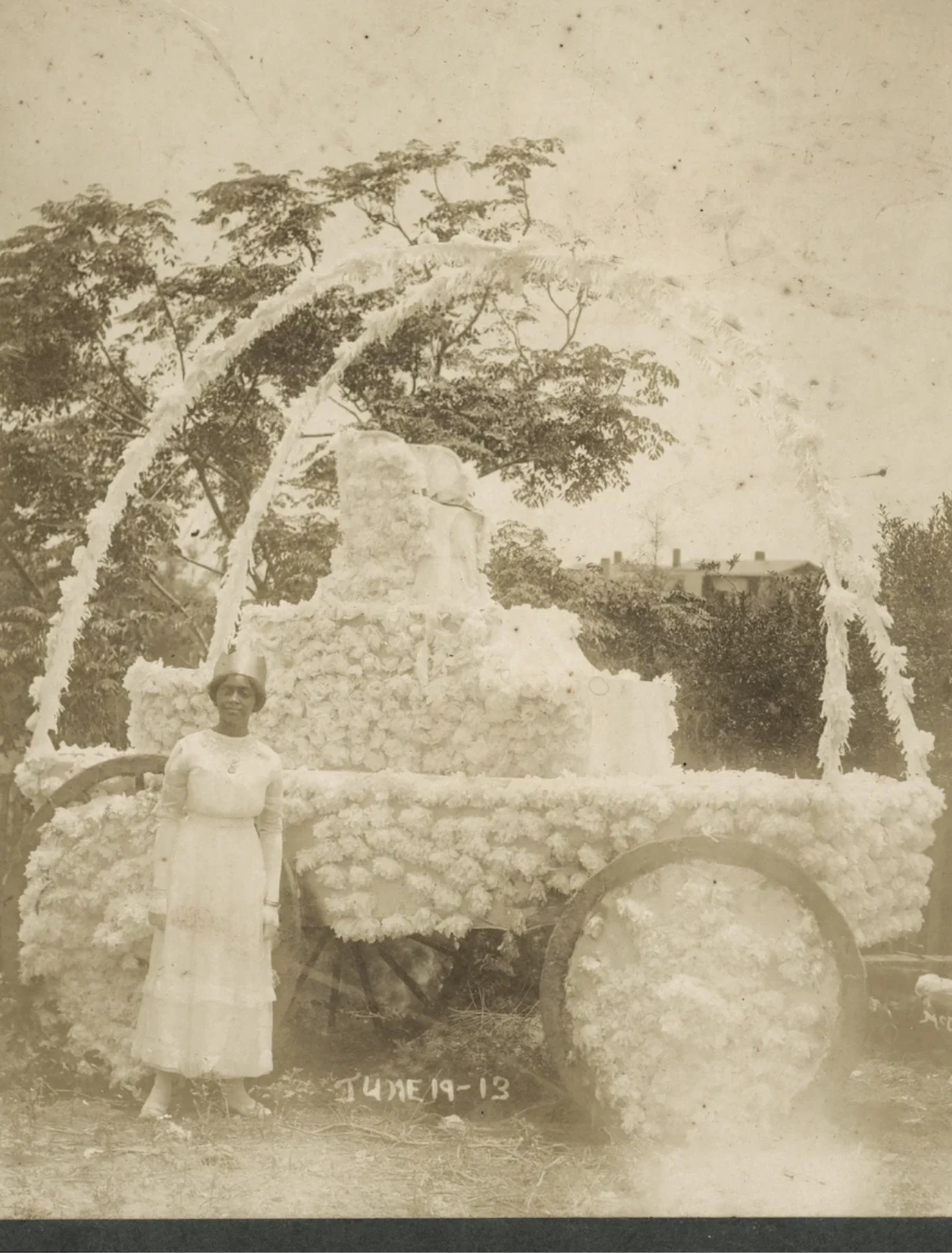 Woman standing before a decorated carriage at Juneteenth celebrations, Corpus Christi, Texas, 1913